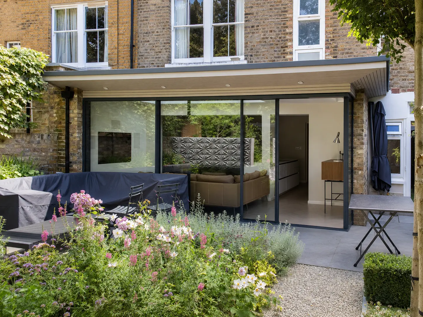 A rear glazed extension and garden built by Rex & Co — Brondesbury Villas, London